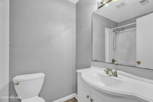 bathroom with toilet, visible vents, a shower, and vanity