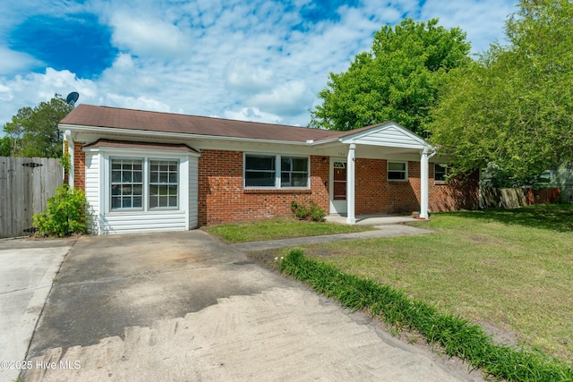 ranch-style house featuring fence, a front yard, and brick siding