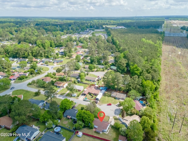 aerial view with a wooded view and a residential view
