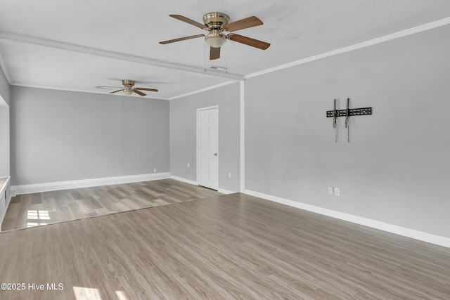 unfurnished living room with wood finished floors, ceiling fan, baseboards, visible vents, and crown molding