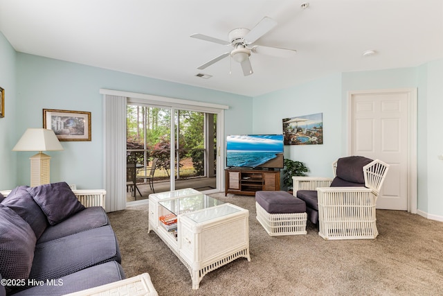 living area with visible vents, ceiling fan, and carpet