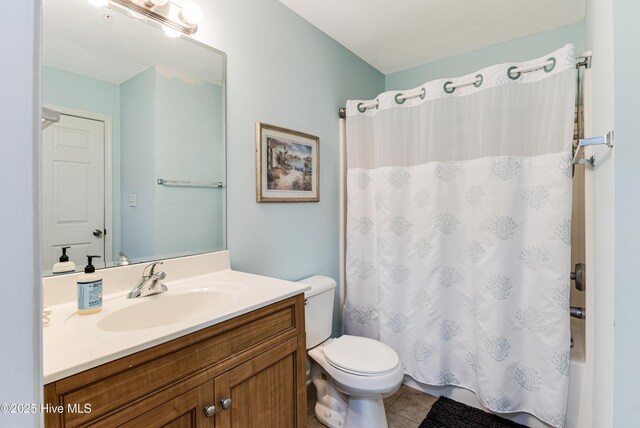 bathroom with toilet, tile patterned floors, shower / bath combo, and vanity