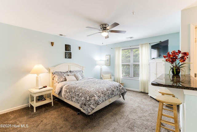 carpeted bedroom with baseboards, visible vents, and a ceiling fan