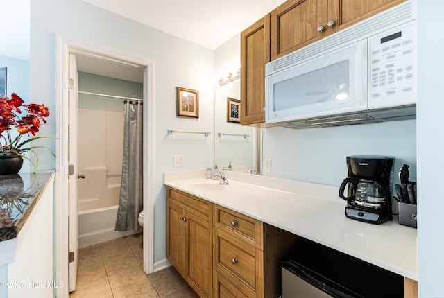 bathroom with toilet, tile patterned flooring, shower / bath combo, and vanity