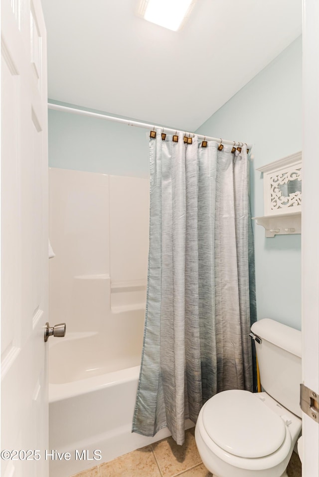 full bathroom featuring toilet, shower / bath combo, and tile patterned floors
