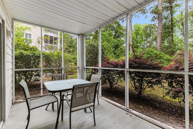 sunroom / solarium featuring outdoor dining space