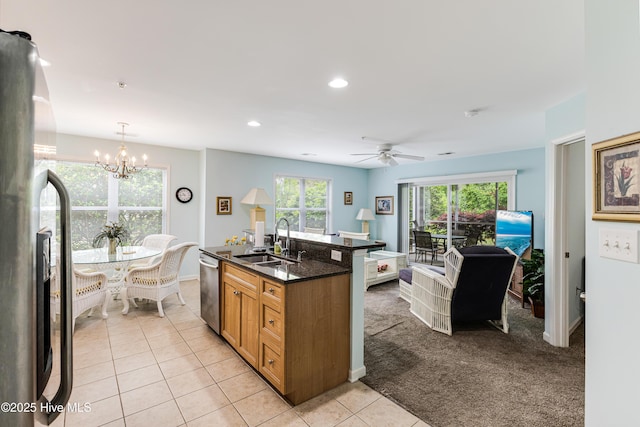 kitchen featuring ceiling fan with notable chandelier, plenty of natural light, appliances with stainless steel finishes, and a sink
