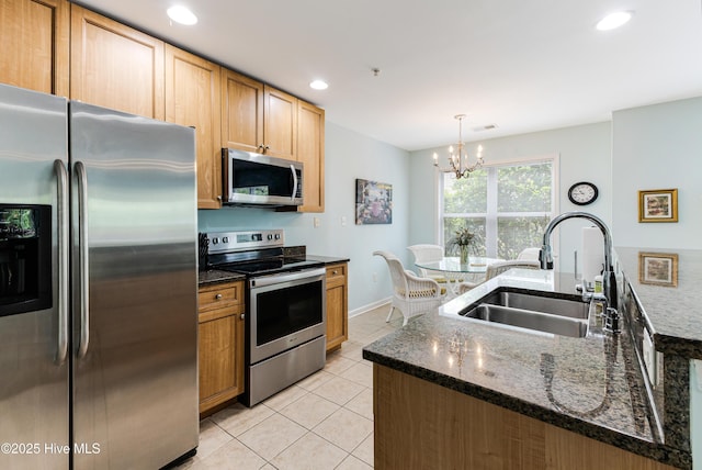 kitchen featuring recessed lighting, light tile patterned floors, appliances with stainless steel finishes, a sink, and a notable chandelier