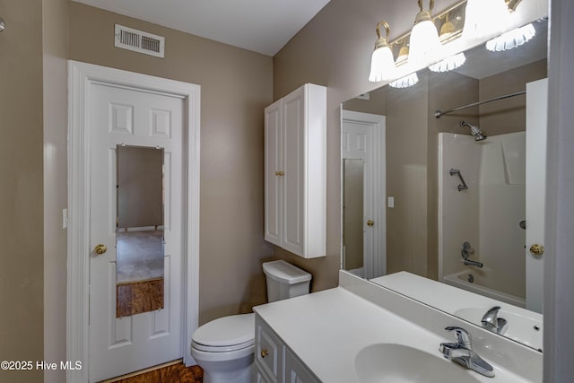 bathroom with vanity, bathtub / shower combination, toilet, and visible vents
