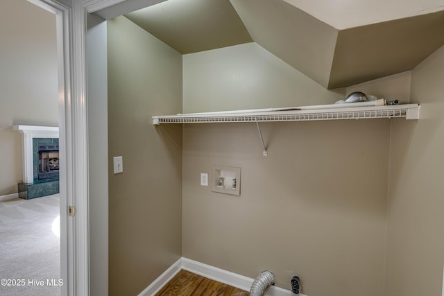 washroom featuring washer hookup, laundry area, baseboards, and a high end fireplace