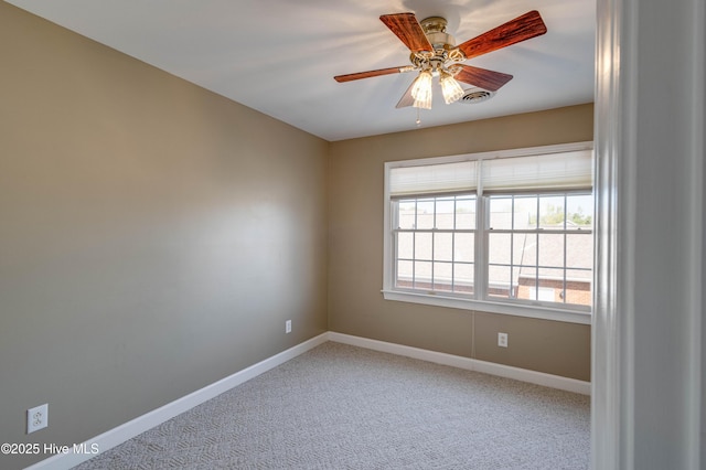unfurnished room featuring baseboards, a ceiling fan, and light carpet