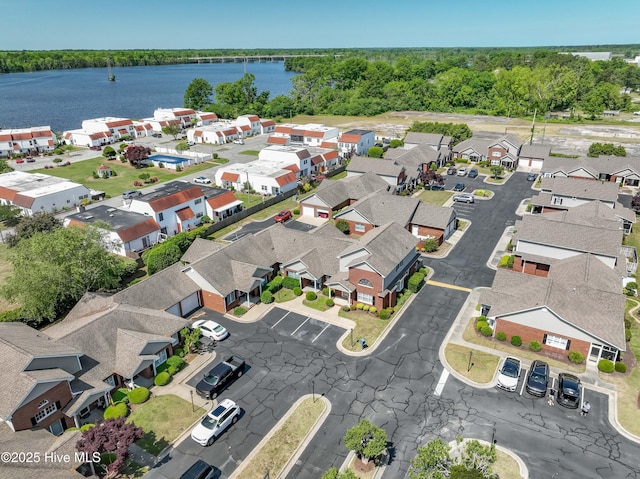 birds eye view of property with a water view and a residential view