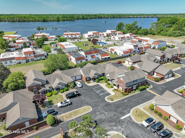 birds eye view of property with a residential view, a water view, and a forest view