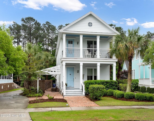 greek revival house with a balcony and a porch