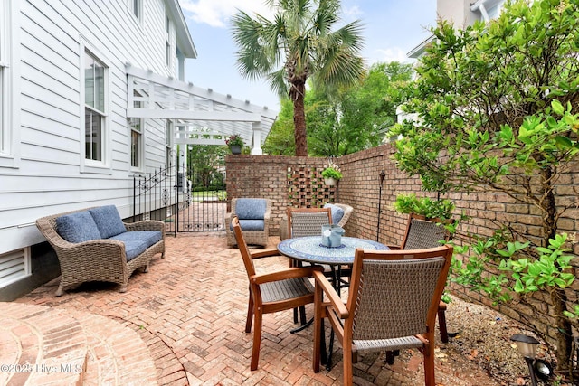 view of patio with a pergola and fence