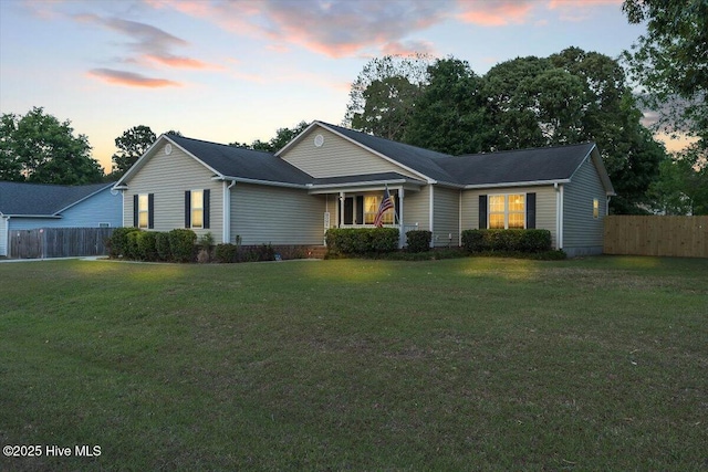 ranch-style house with fence and a front yard