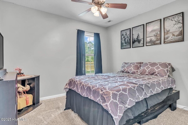 bedroom featuring carpet floors, a ceiling fan, baseboards, and visible vents