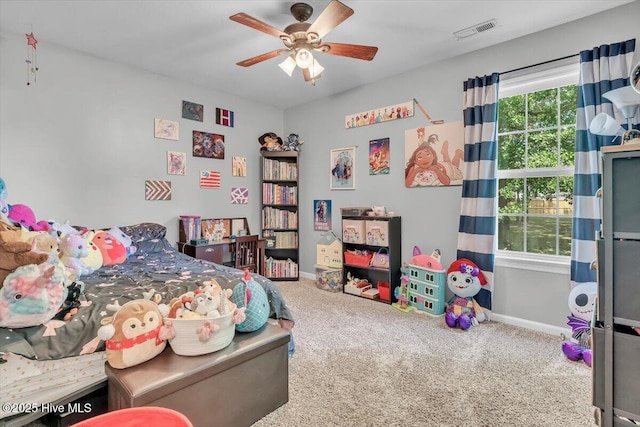 carpeted bedroom featuring visible vents, a ceiling fan, and baseboards