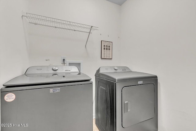 washroom with washing machine and clothes dryer and laundry area