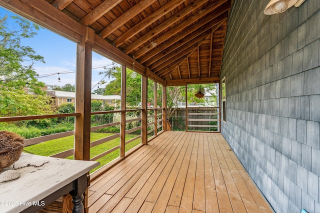 sunroom / solarium featuring beamed ceiling