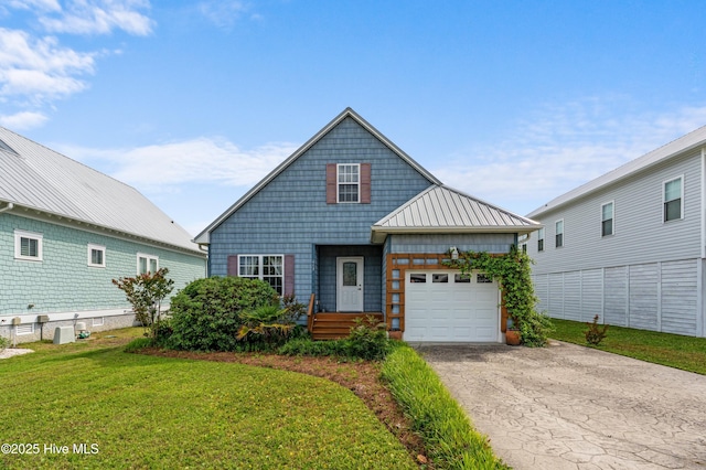 view of front of house featuring a front lawn, a standing seam roof, metal roof, driveway, and an attached garage