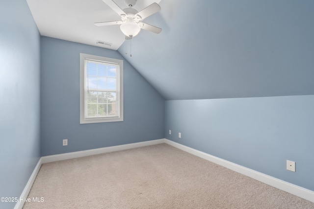 bonus room featuring lofted ceiling, visible vents, ceiling fan, baseboards, and carpet floors
