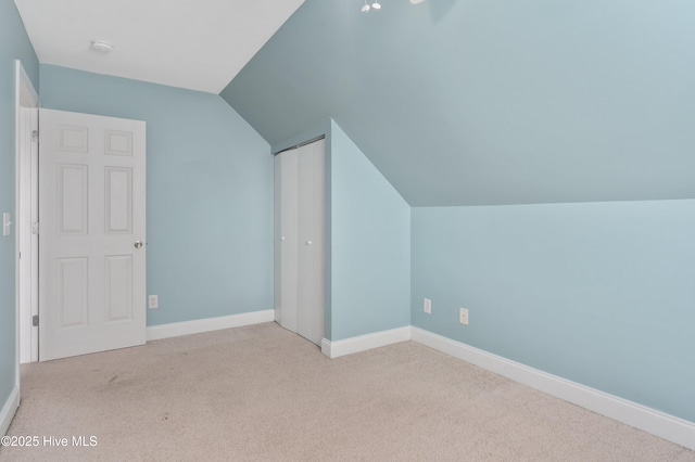 bonus room with baseboards, carpet floors, and vaulted ceiling