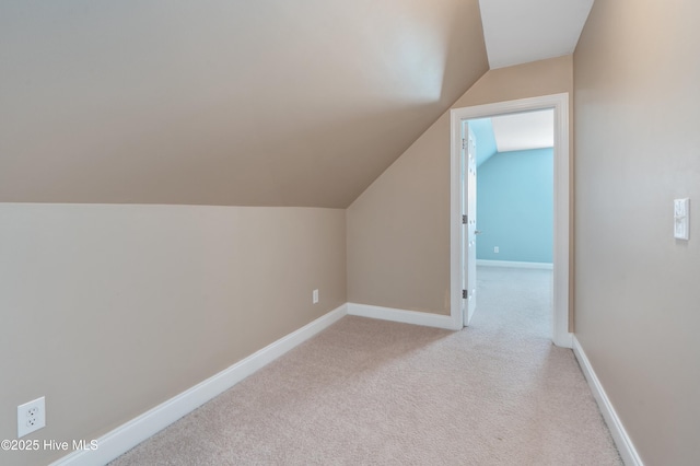 bonus room featuring light carpet, lofted ceiling, and baseboards