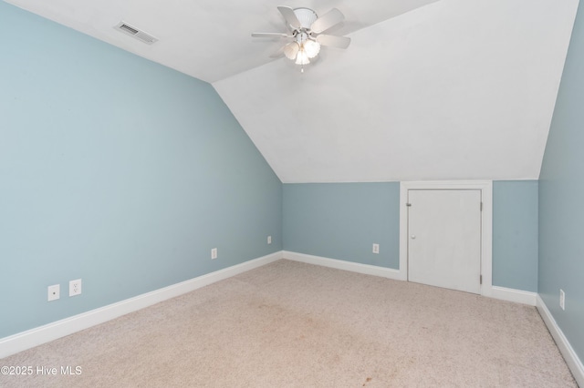 additional living space featuring vaulted ceiling, ceiling fan, carpet flooring, baseboards, and visible vents