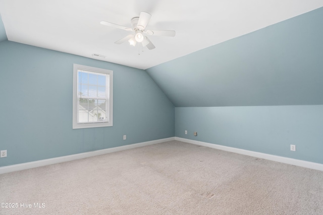 bonus room with lofted ceiling, carpet flooring, visible vents, baseboards, and a ceiling fan