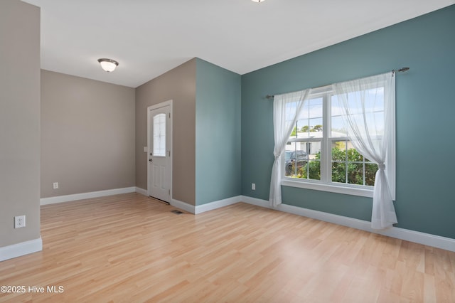 foyer entrance featuring wood finished floors and baseboards