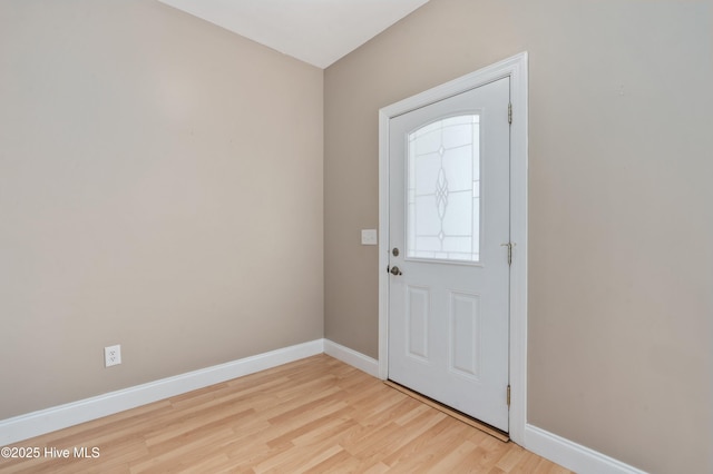 entryway featuring baseboards and light wood finished floors