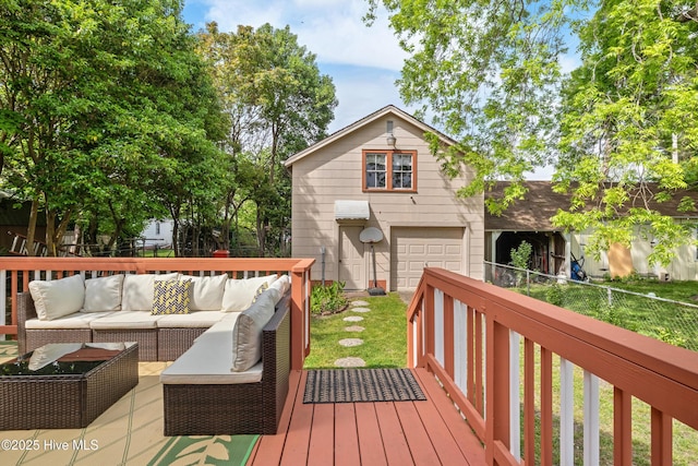 deck with outdoor lounge area, fence, and a garage