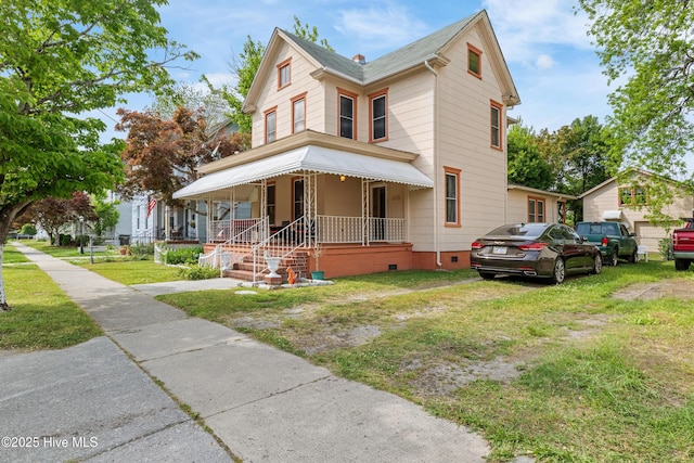 victorian-style house with a porch, crawl space, and a front lawn