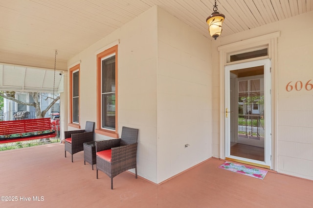 view of exterior entry with covered porch