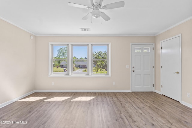 entryway featuring ceiling fan, baseboards, wood finished floors, visible vents, and ornamental molding
