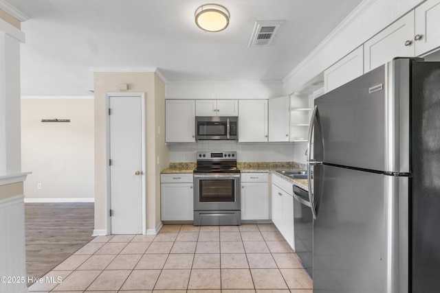 kitchen featuring visible vents, open shelves, crown molding, white cabinetry, and appliances with stainless steel finishes