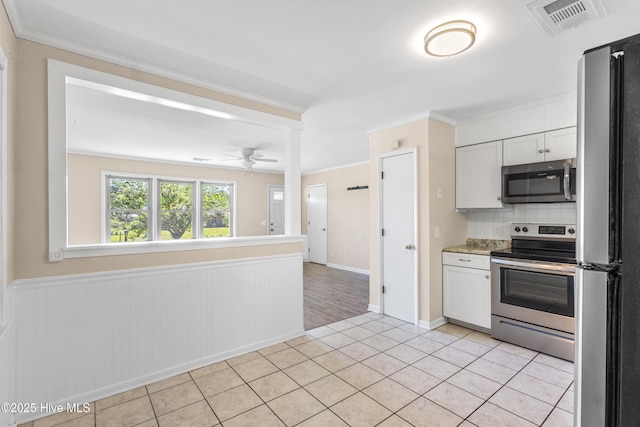 kitchen with stainless steel appliances, light tile patterned floors, backsplash, visible vents, and ornamental molding