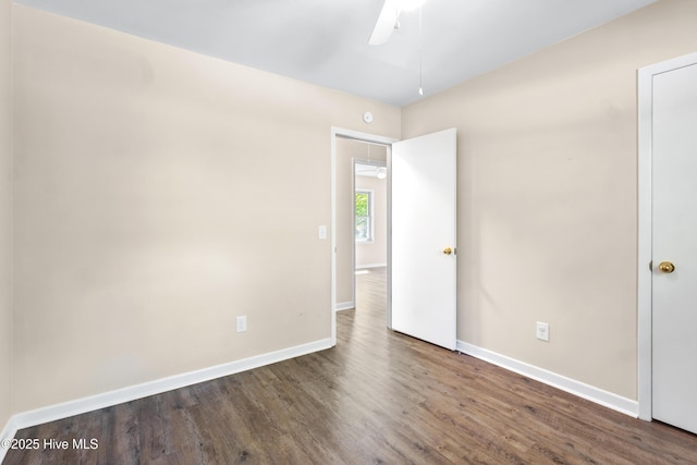 spare room featuring a ceiling fan, baseboards, and wood finished floors