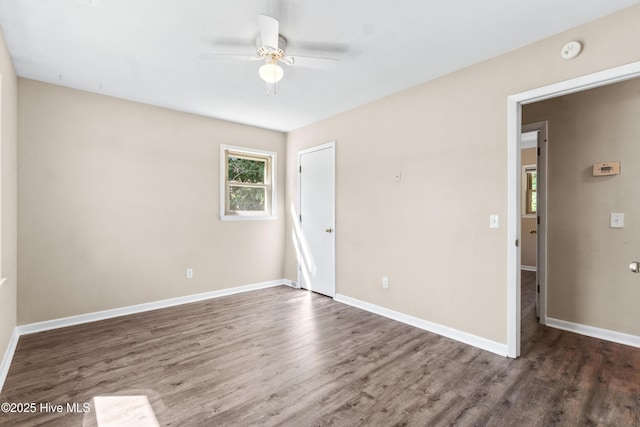 unfurnished room with baseboards, a ceiling fan, and wood finished floors