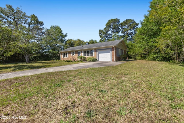 single story home featuring brick siding, a garage, a front lawn, and driveway