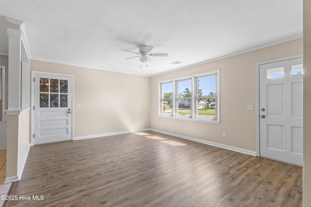 unfurnished living room with ornamental molding, a ceiling fan, wood finished floors, and visible vents