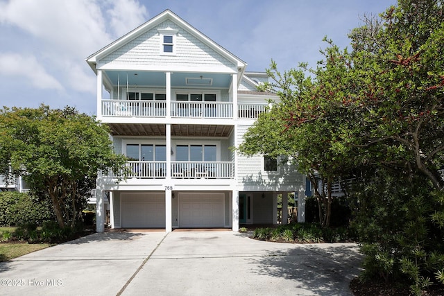768 S Lumina Ave, Wrightsville Beach, NC 28480 - coastal home with a balcony, an attached garage, and driveway