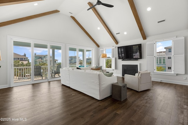 768 S Lumina Ave, Wrightsville Beach, NC 28480 - living room featuring a glass covered fireplace, high vaulted ceiling, beam ceiling, ceiling fan, and dark wood-style flooring