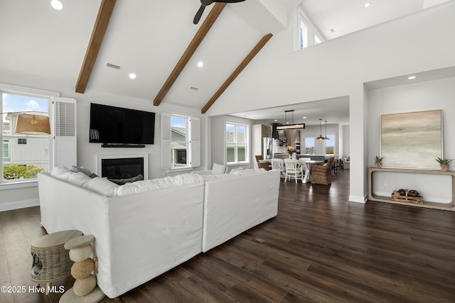 768 S Lumina Ave, Wrightsville Beach, NC 28480 - living room with high vaulted ceiling, a glass covered fireplace, dark wood-type flooring, beamed ceiling, and recessed lighting