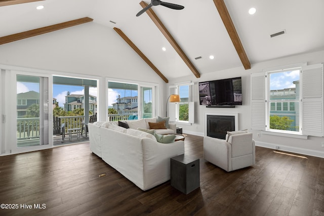 768 S Lumina Ave, Wrightsville Beach, NC 28480 - living room with high vaulted ceiling, a glass covered fireplace, beamed ceiling, a ceiling fan, and dark wood-style flooring
