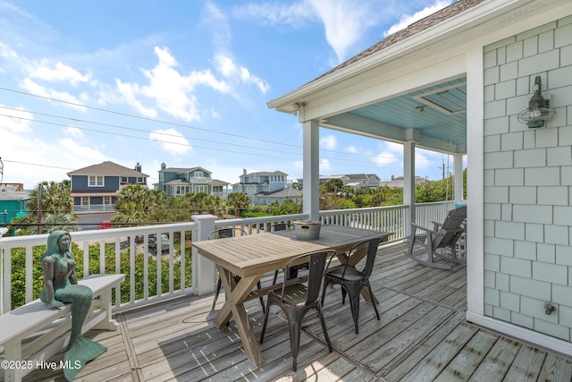 768 S Lumina Ave, Wrightsville Beach, NC 28480 - wooden terrace with outdoor dining area and a residential view