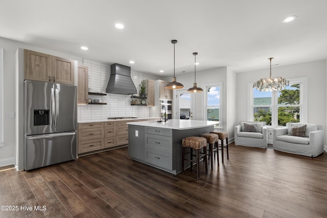 768 S Lumina Ave, Wrightsville Beach, NC 28480 - kitchen featuring appliances with stainless steel finishes, custom range hood, light countertops, dark wood-type flooring, and recessed lighting