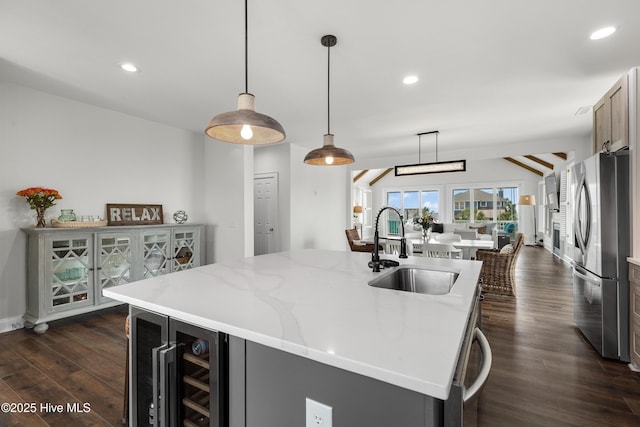 768 S Lumina Ave, Wrightsville Beach, NC 28480 - kitchen featuring freestanding refrigerator, a sink, an island with sink, dark wood finished floors, and beverage cooler