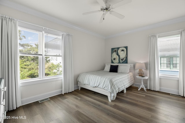 768 S Lumina Ave, Wrightsville Beach, NC 28480 - bedroom featuring crown molding, wood finished floors, multiple windows, baseboards, and a ceiling fan